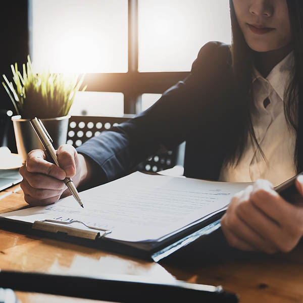 Lawyer woman holding pen with contract